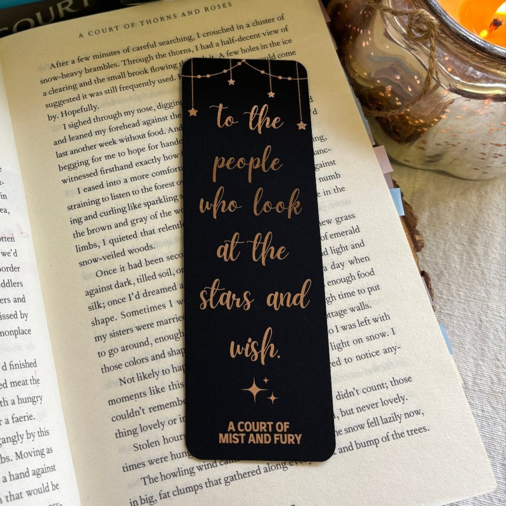 bookmark is laid out on a page of an open book