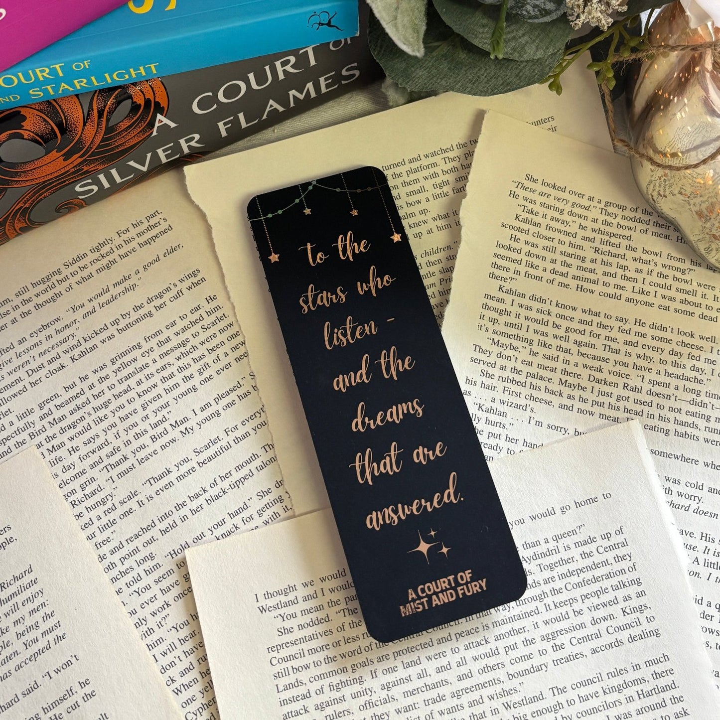 rose gold foil bookmark laid out on loose book pages